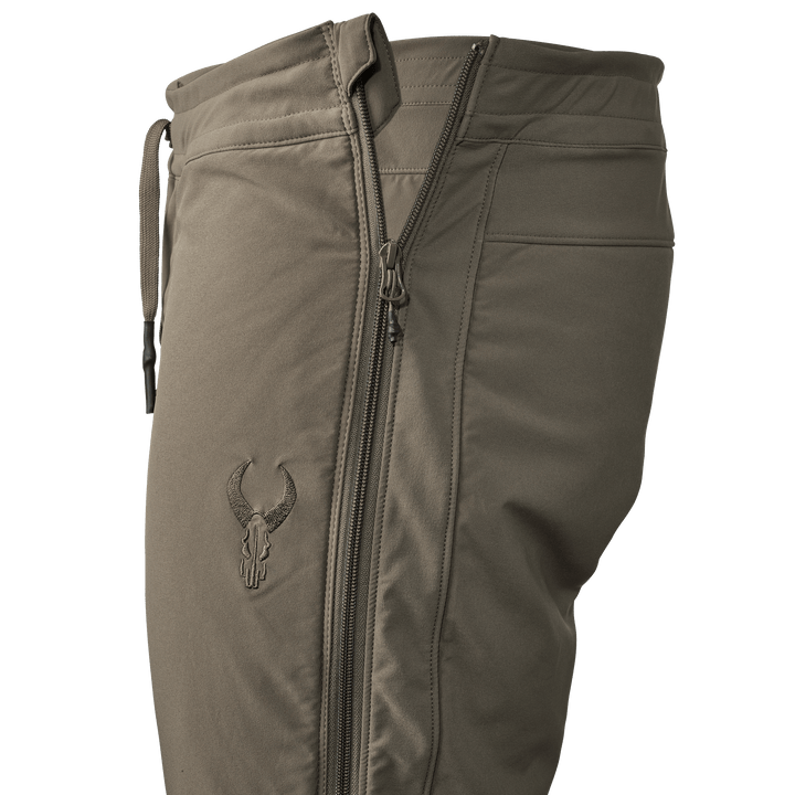 Tan Badlands pants with side zipper and embroidered Badlands skull logo on the thigh.