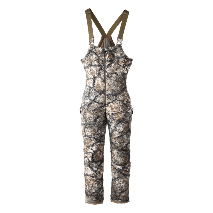 Badlands camo hunting bib with front zipper and logo skull on chest; adjustable straps for comfort and fit.
