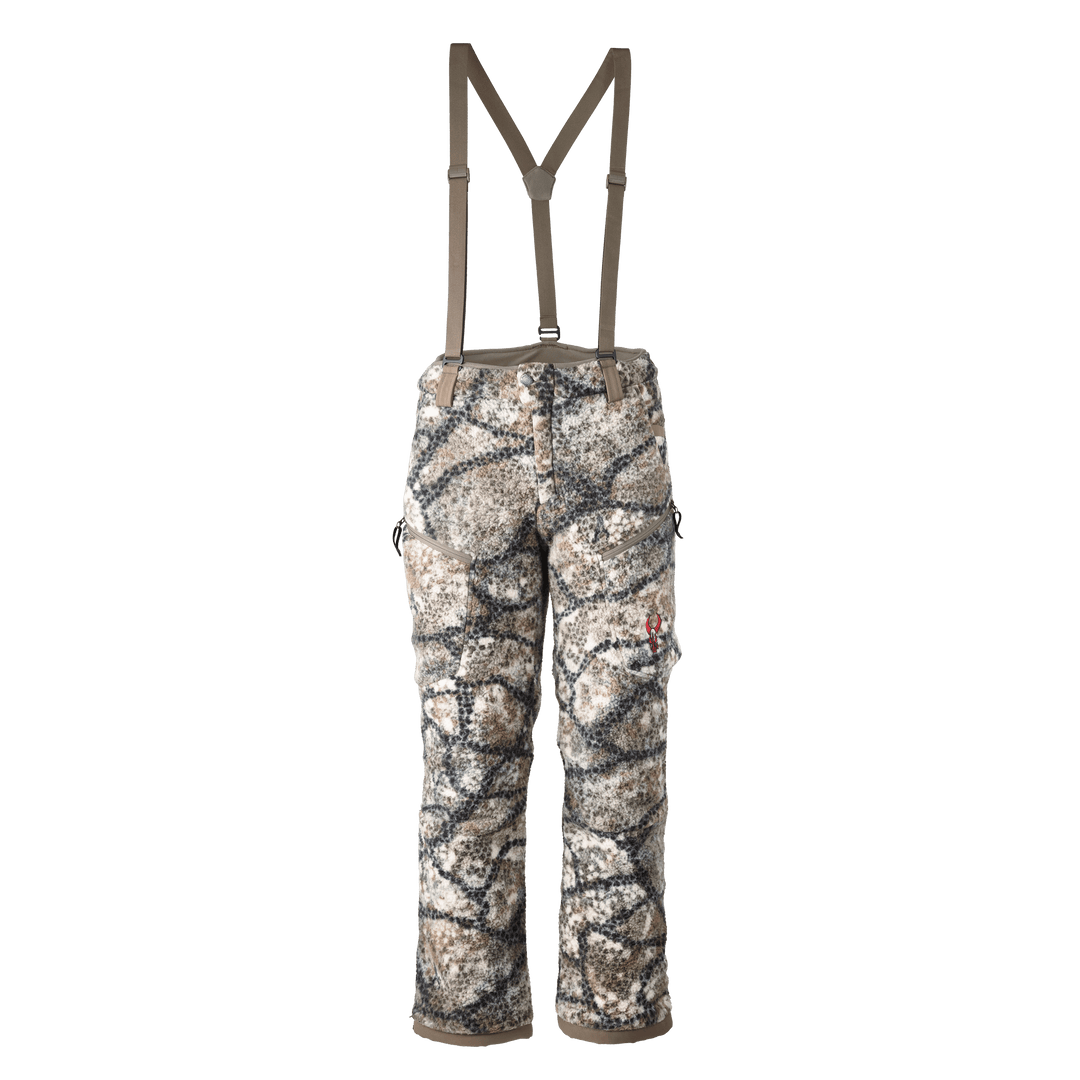 Badlands camo hunting pants with suspenders, side pockets, and Badlands skull logo on right leg.