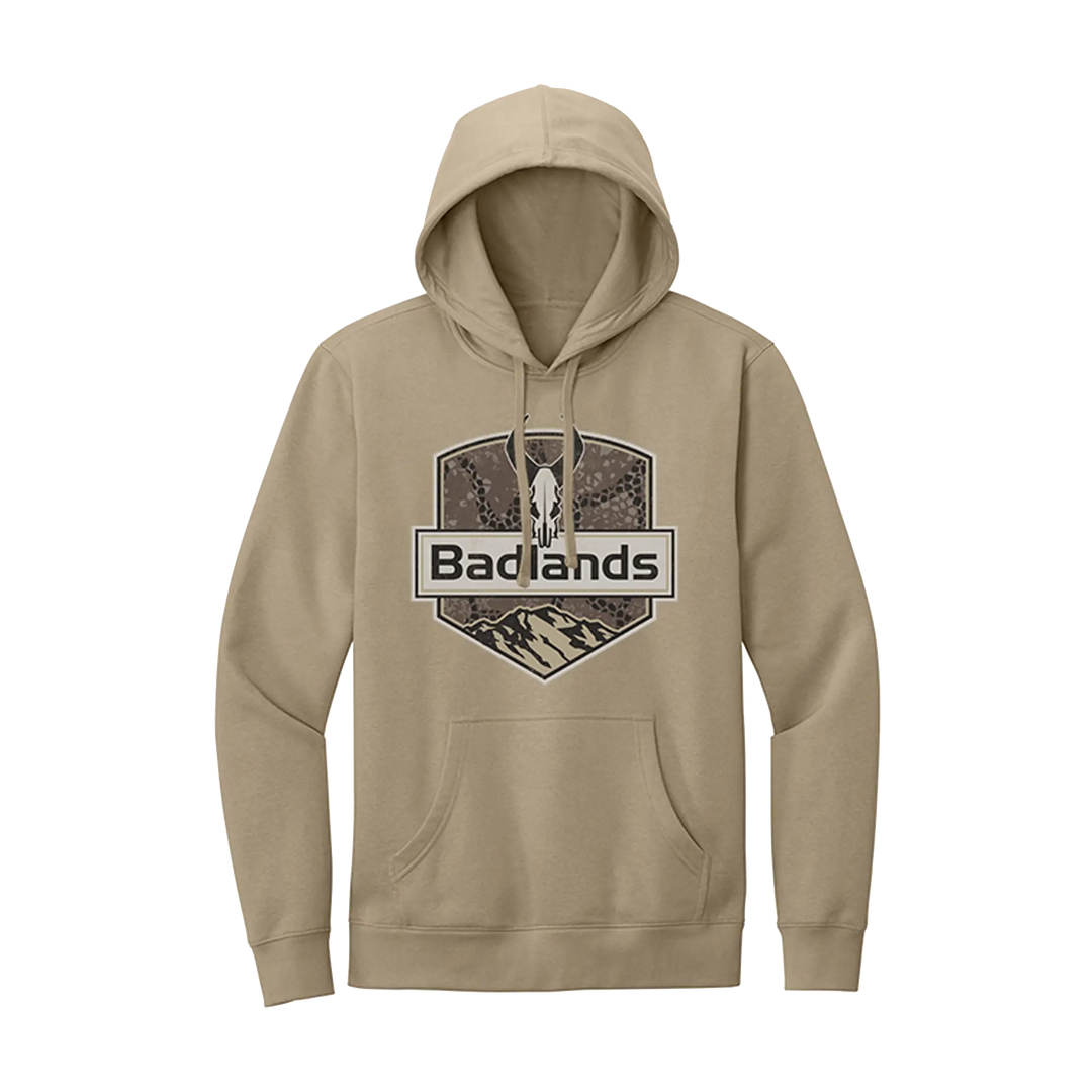 Tan hoodie with Badlands logo, featuring a skull and mountain graphic on the chest; front pocket and drawstring hood.