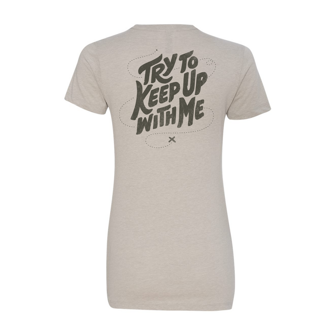 Tan Badlands t-shirt with "Try to Keep Up With Me" text and a small Badlands skull logo on the back.