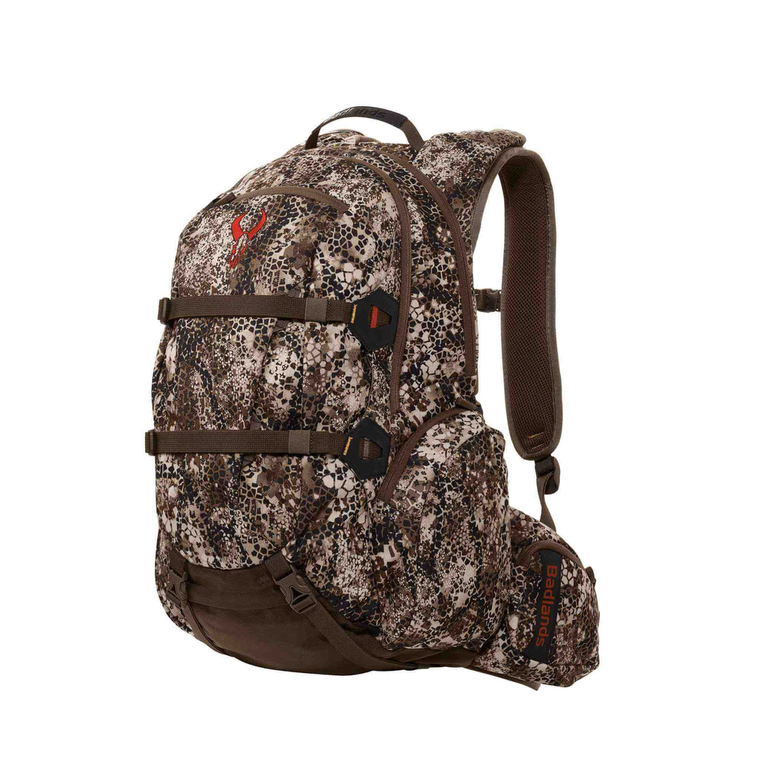 Badlands camo hunting backpack with red skull logo, padded straps, and multiple compartments for outdoor gear.