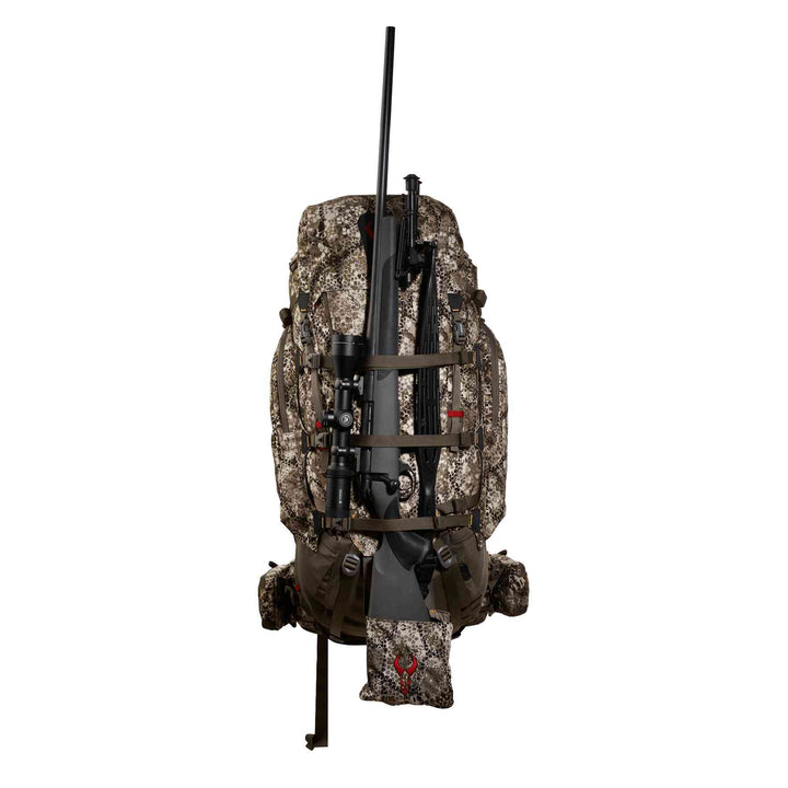 Badlands camo hunting backpack with rifle holder; red skull logo visible on lower pouch.
