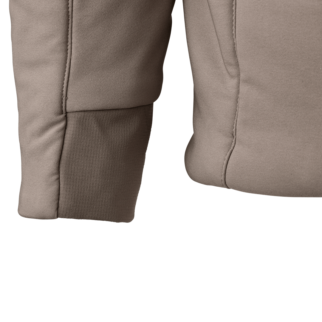 Close-up of tan Badlands jacket sleeve and side, showing stitching and fabric texture.