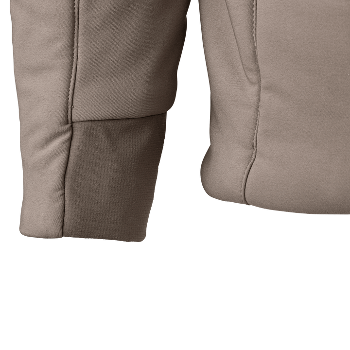 Close-up of tan Badlands jacket sleeve and side, showing stitching and fabric texture.