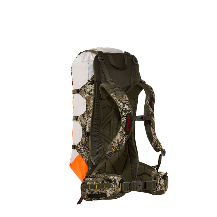 Badlands hunting backpack with camo straps, orange accents, and skull logo on shoulder strap, shown from the back.