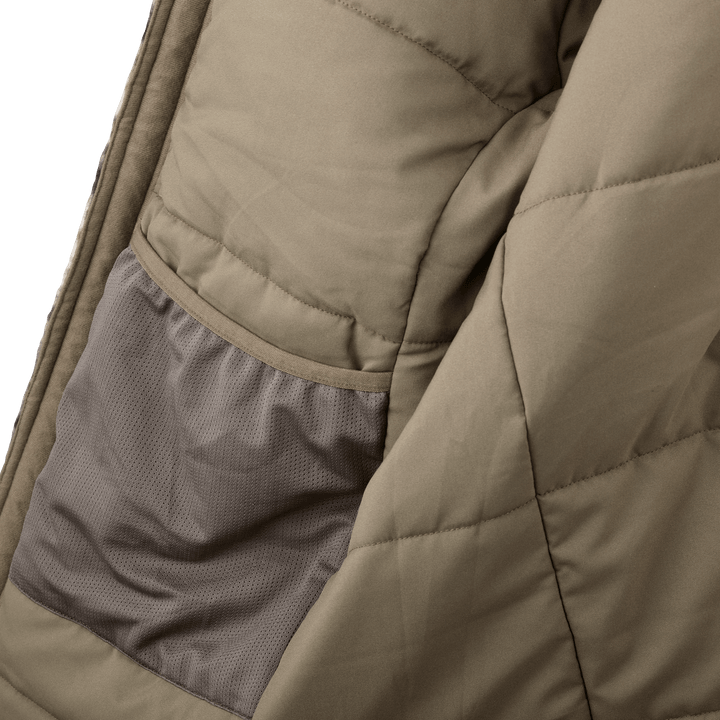 Close-up of a Badlands jacket interior mesh pocket, showing tan quilted fabric and detailed stitching.