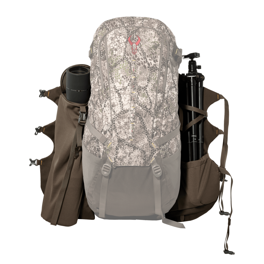 Badlands camo backpack with skull logo, side pockets hold a lens and tripod; accessible, organized outdoor gear storage.
