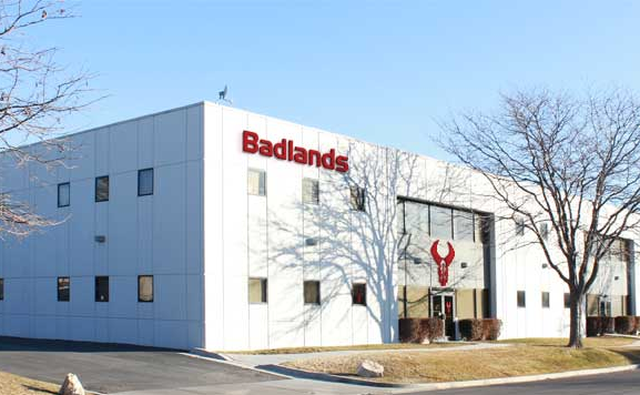 Badlands office building with logo skull above entrance, accessible sidewalk, and clear signage.